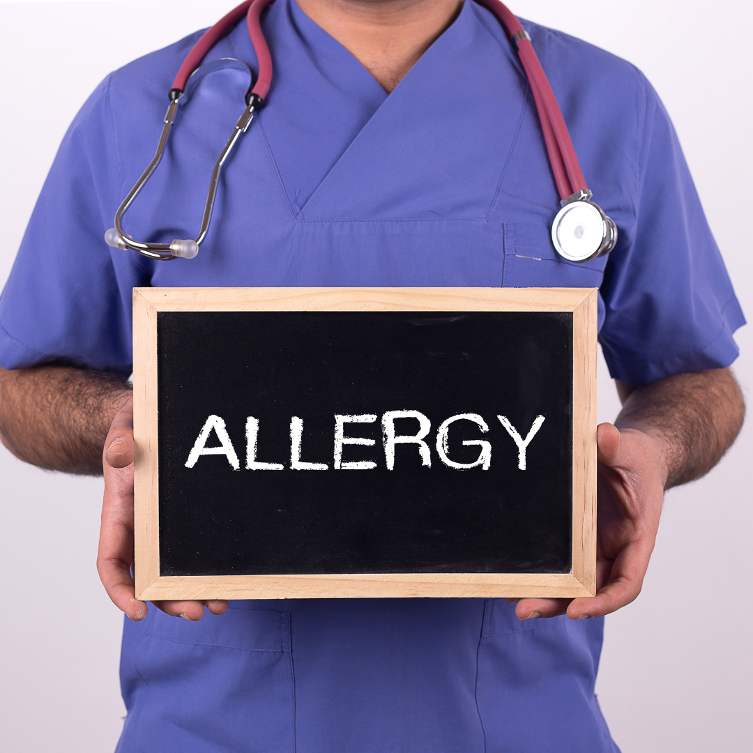 MD with a board that says allergies