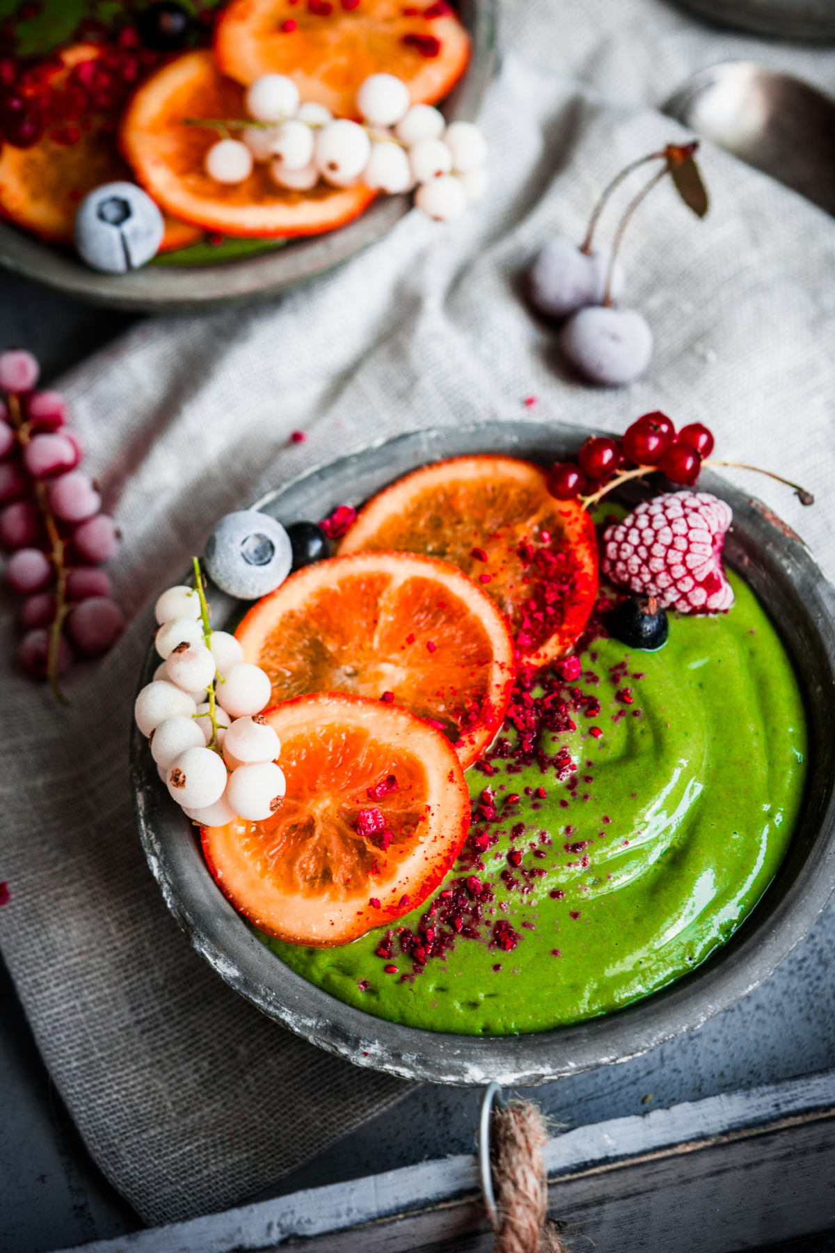 Green smoothie bowl with fruits on it