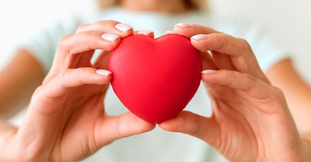 woman holding a heart