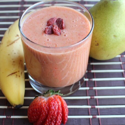 Strawberry smoothie with banana and pear on the side