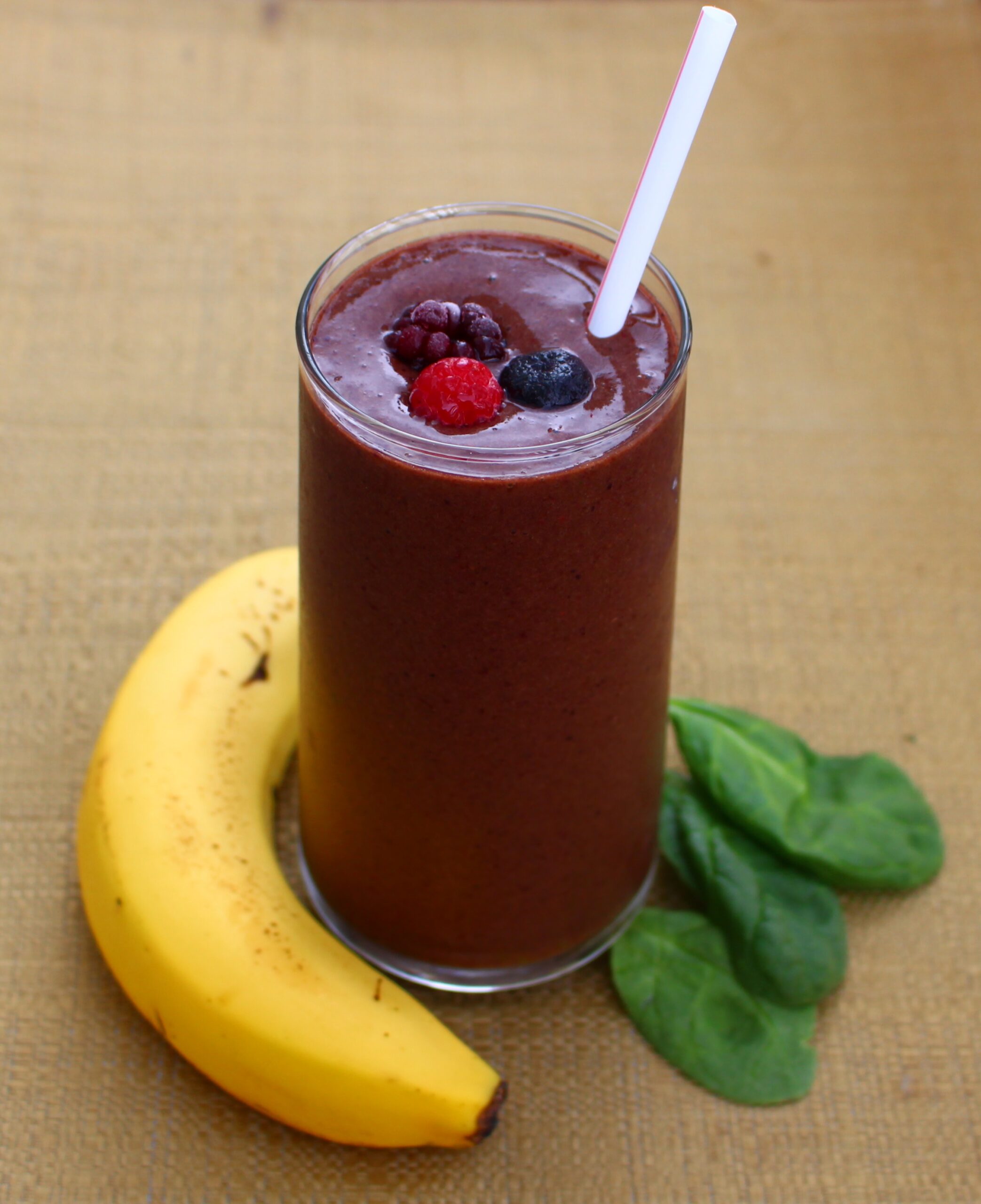 Savor the refreshing blend of frozen mixed berries, banana, and spinach in this indulgent smoothie. A delightful treat in every sip!