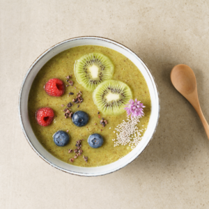 smoothie bowl with fruits in it and a spoon on the right side