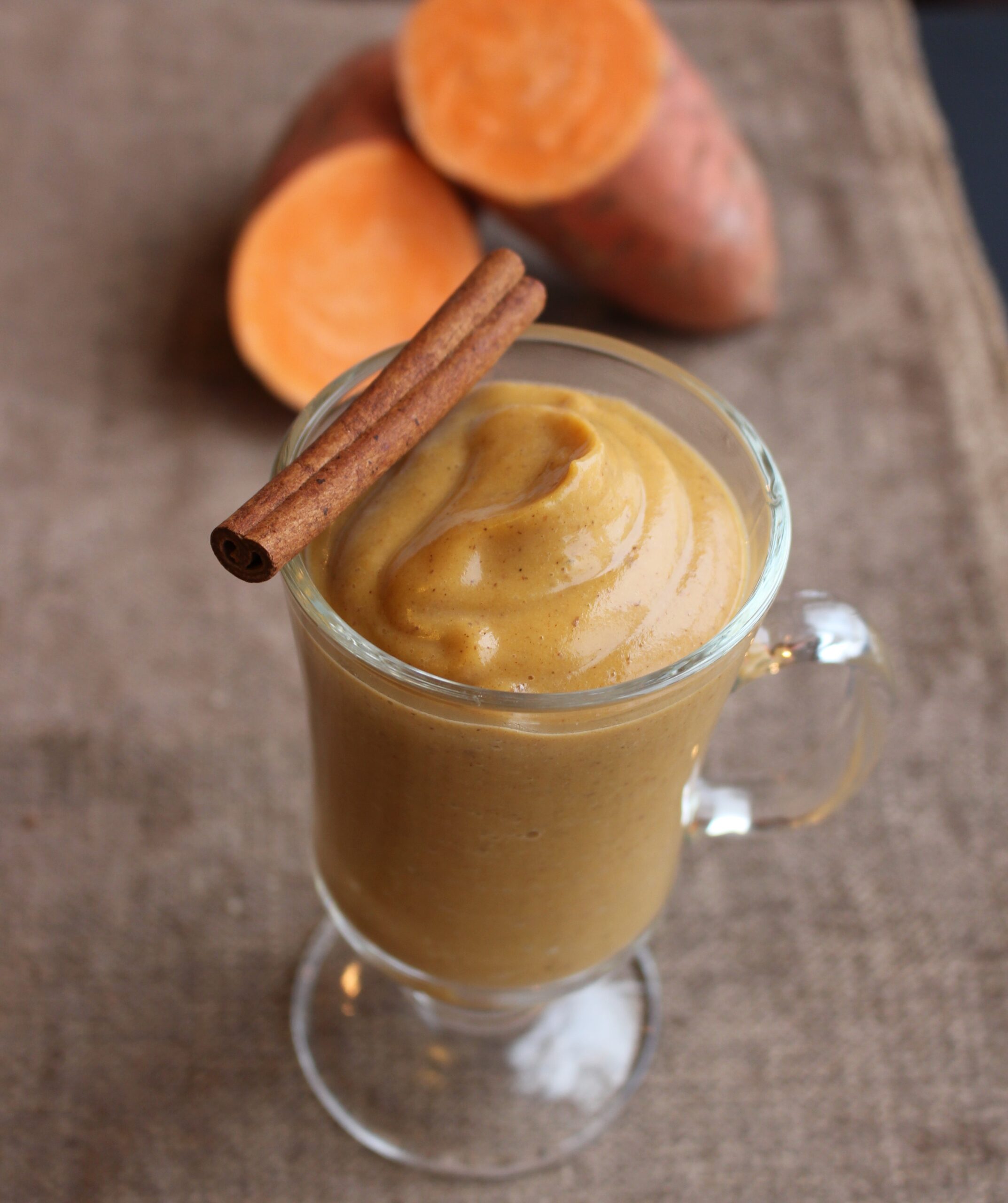 Creamy smoothie and weet potato on side and cinnamon on top