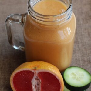 Smoothie with grapefruit and cucumber on the side.