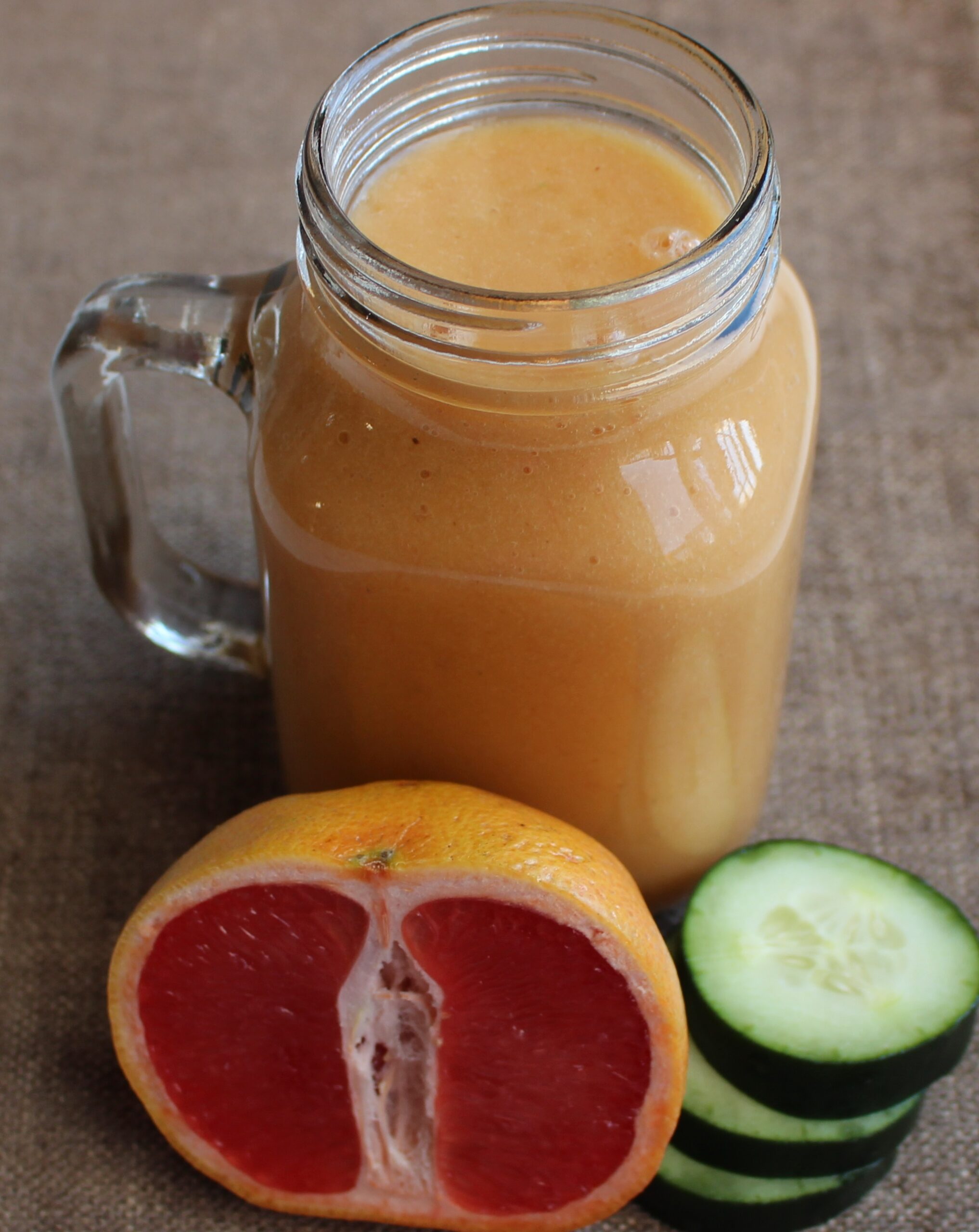 Smoothie with grapefruit and cucumber on the side.