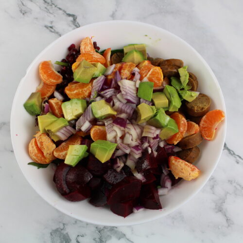 Salad bowl with cuties, onions beets and avocado