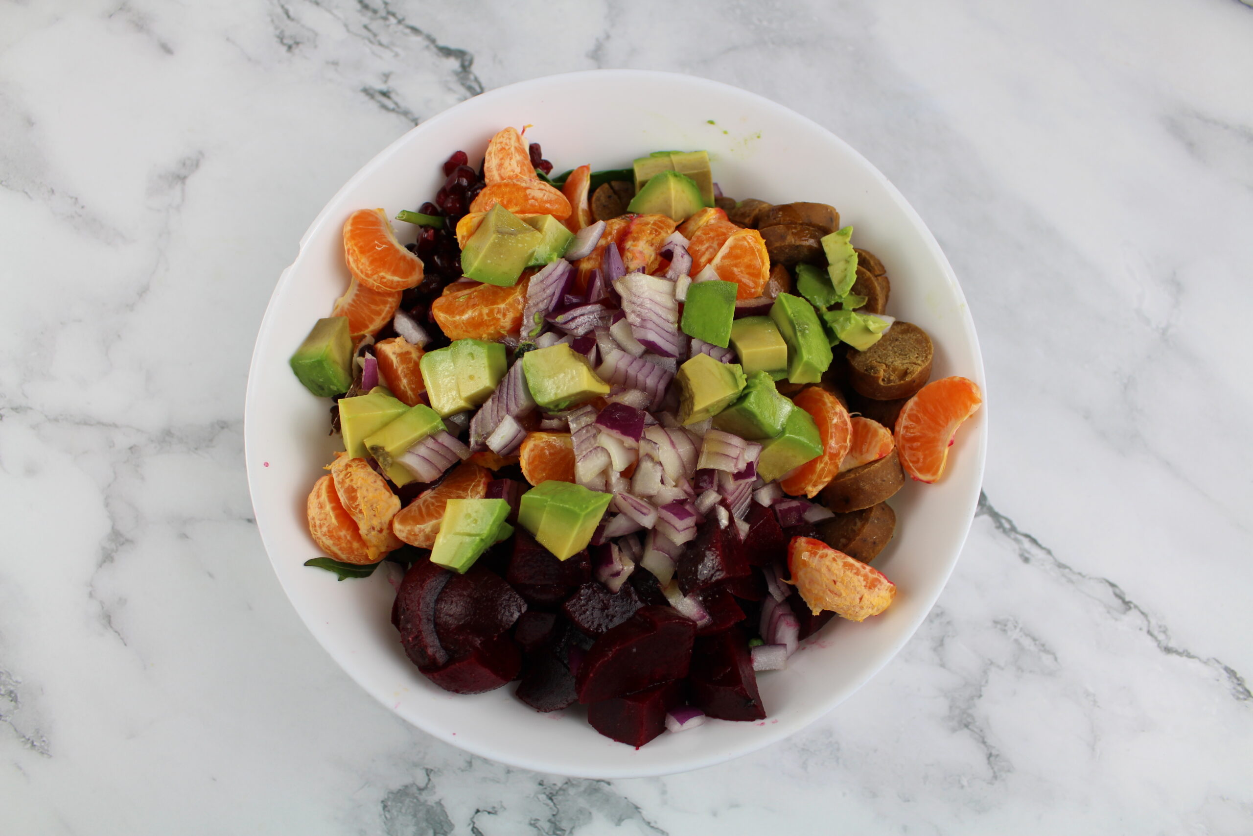 Salad bowl with cuties, onions beets and avocado