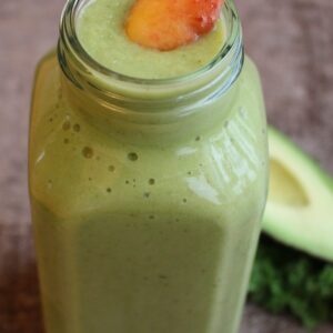 green smoothie with peach on top