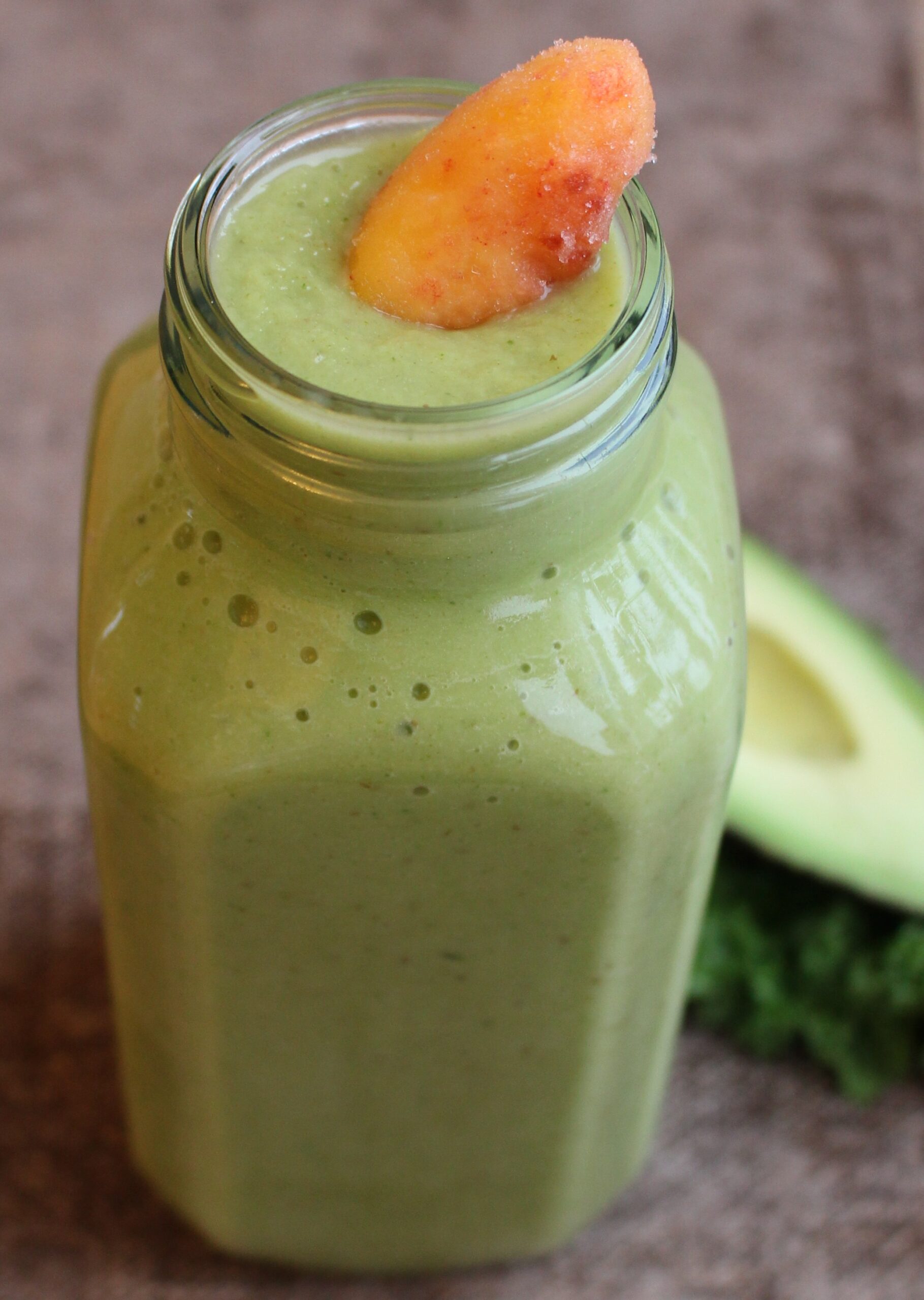 green smoothie with peach on top