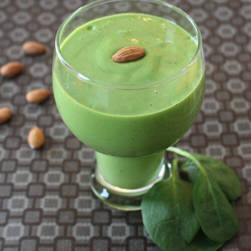 green smoothie with spinach and almonds on the side
