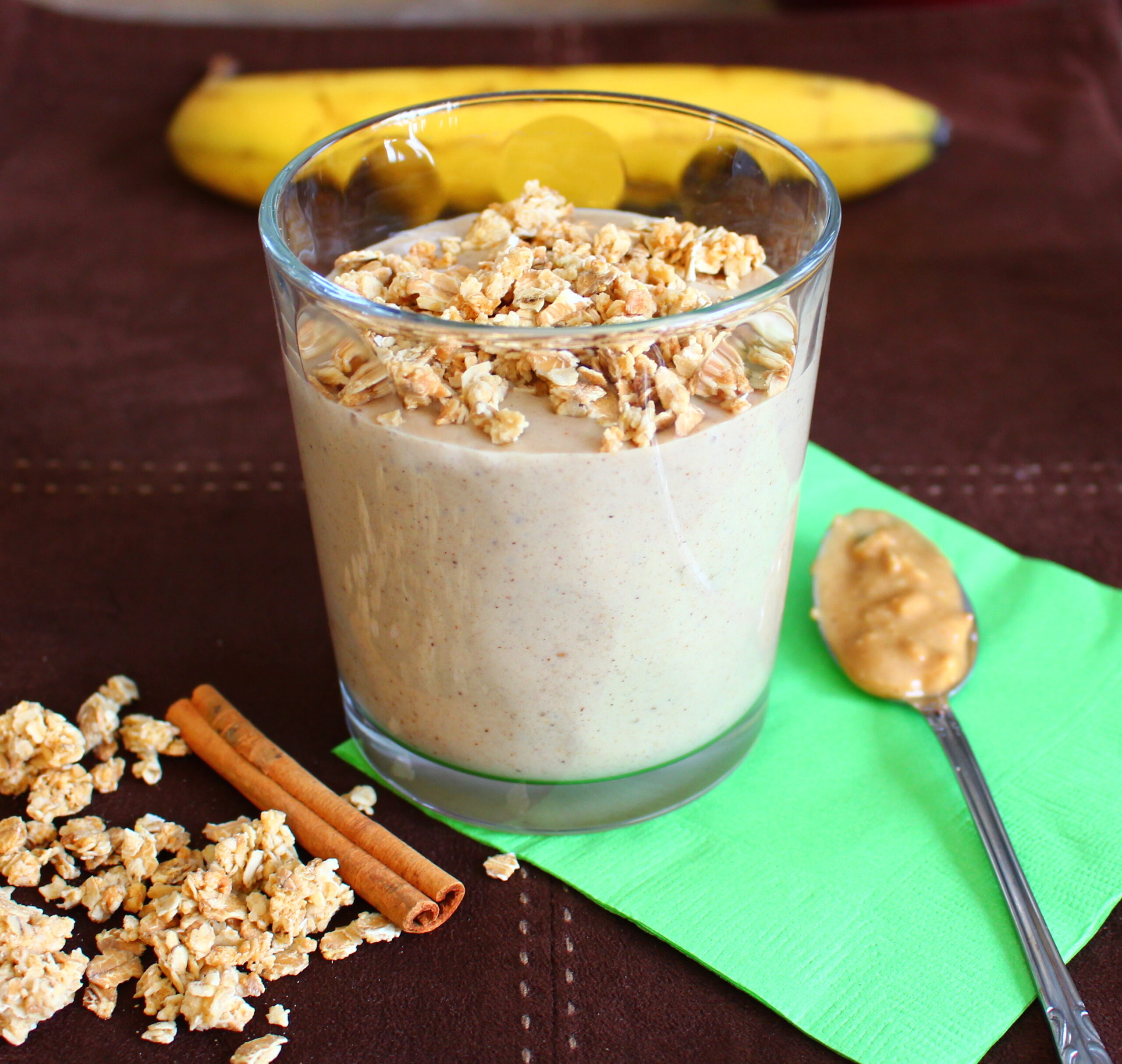 creamy peanut butter smoothie with granola and cinnamon