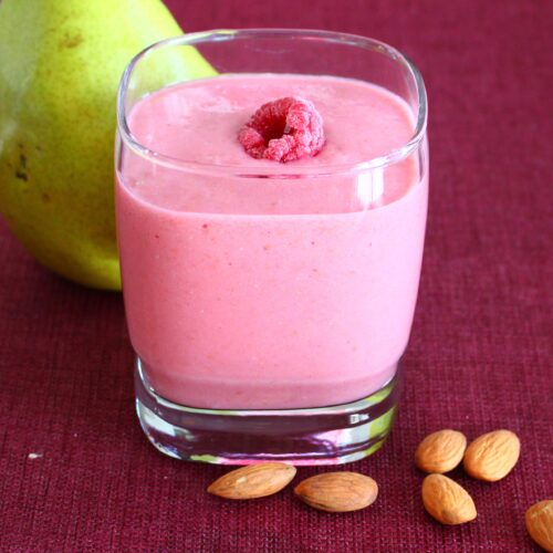 raspberries smoothie with pear and almonds on the side