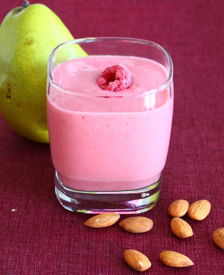 raspberries smoothie with pear and almonds on the side