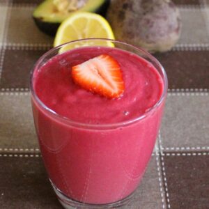 strawberry smoothie with lemon and avocado on the side