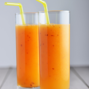 orange and apple smoothie in tall glasses