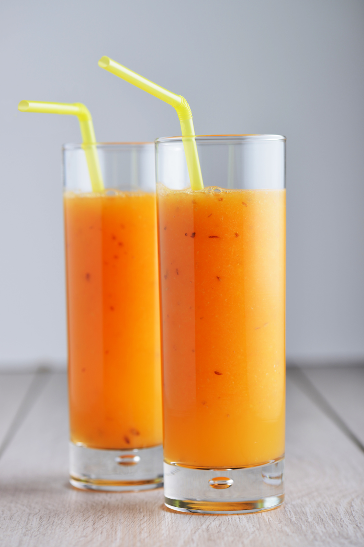 orange and apple smoothie in tall glasses