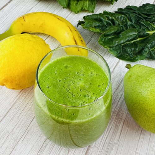 Green smoothie with apple lemon romaine and pear next to it