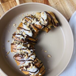banana in a puff pastry with chocolate on top
