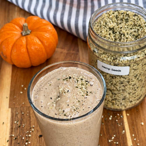 pumpkin puree smoothie with hemp seeds and pumpkins around it