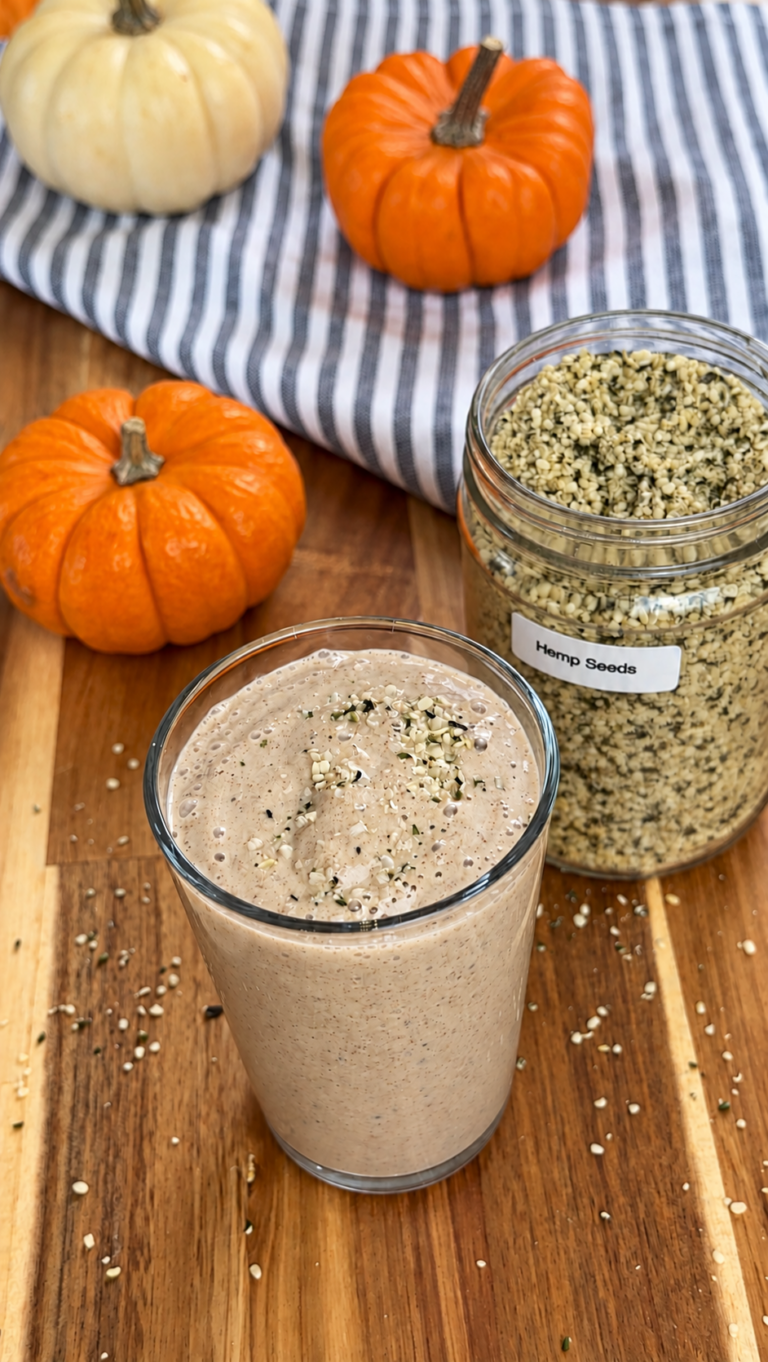 pumpkin puree smoothie with hemp seeds and pumpkins around it