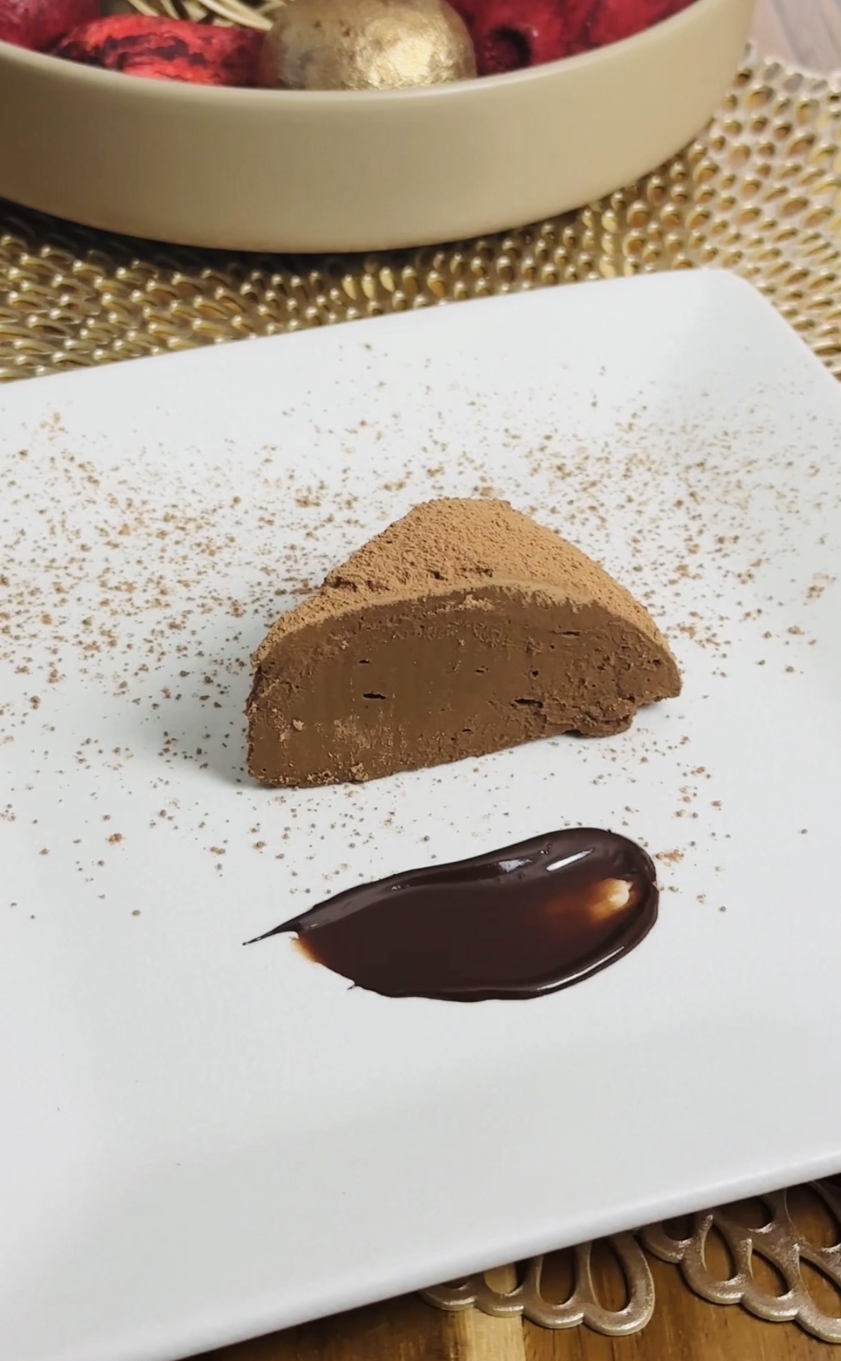Sweet Potato Chocolate Fudge Cake in a white plate with a little dark chocolate next to it.